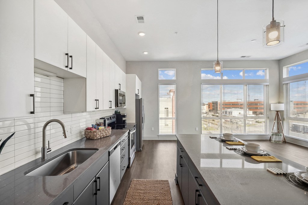 a large kitchen with a sink and a window