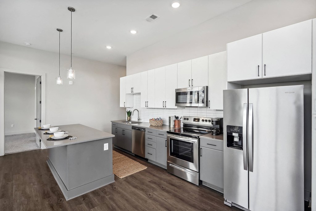 a kitchen with stainless steel appliances and white cabinets