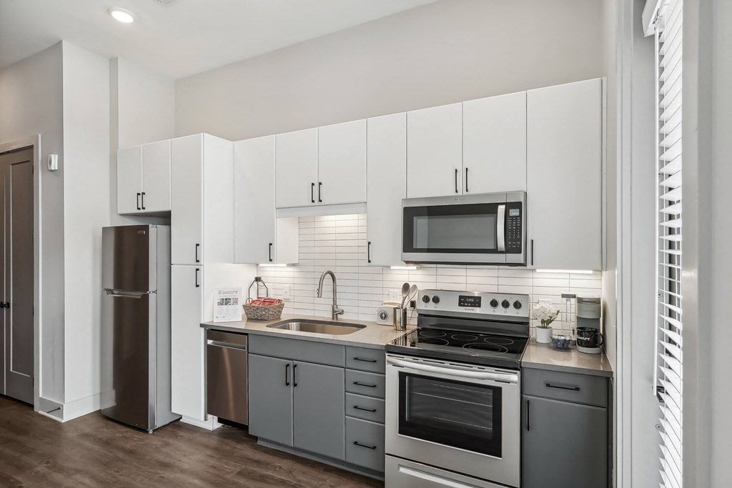 a kitchen with stainless steel appliances and white cabinets