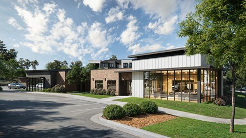 A modern building with a parking lot in front.