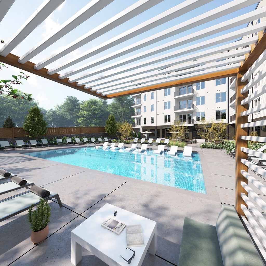a swimming pool at a hotel with lounge chairs