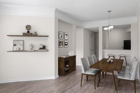 a dining room and living room with a wooden table and chairs