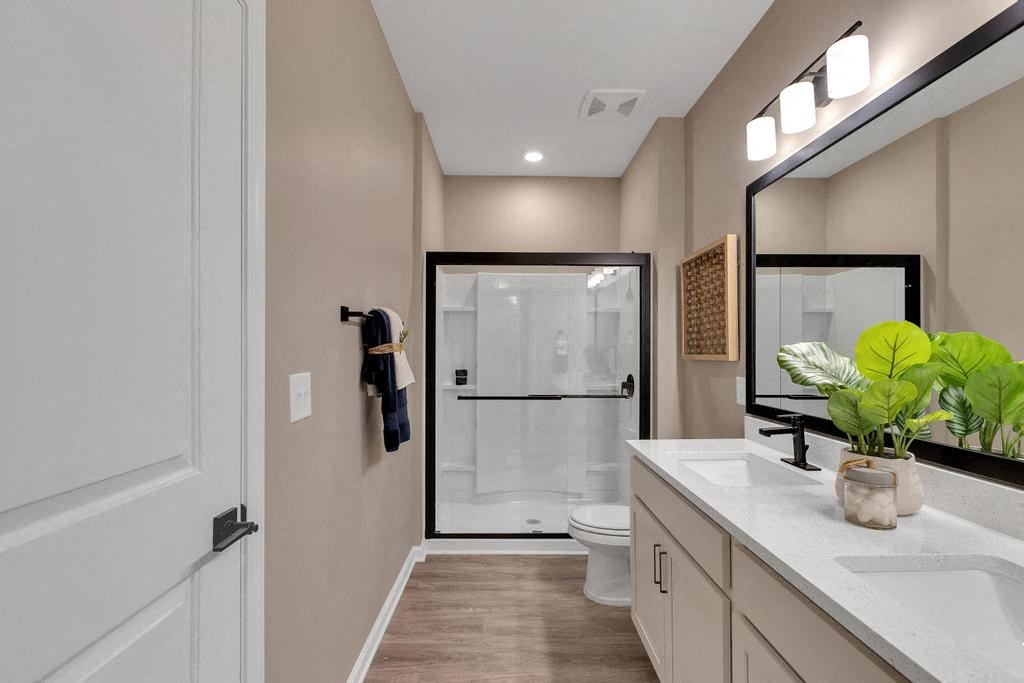 a bathroom with a shower and a sink and a mirror