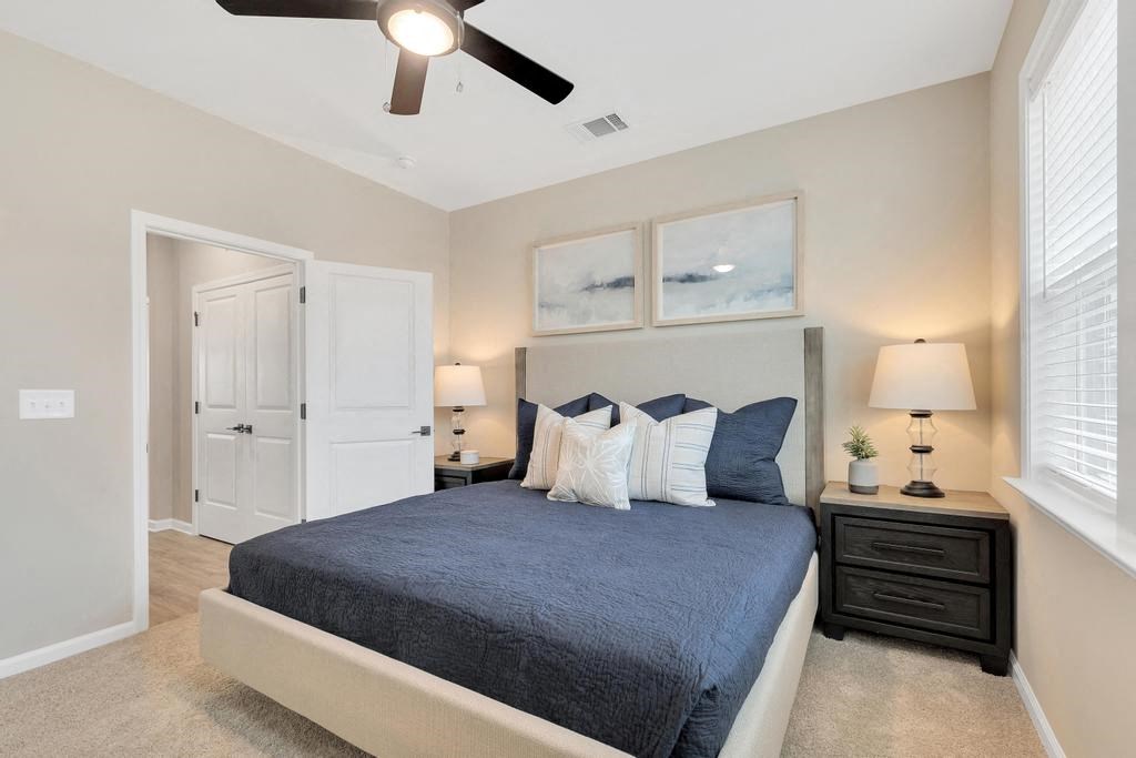 a bedroom with a bed and a ceiling fan