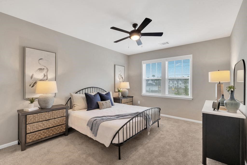 a bedroom with a bed and a ceiling fan