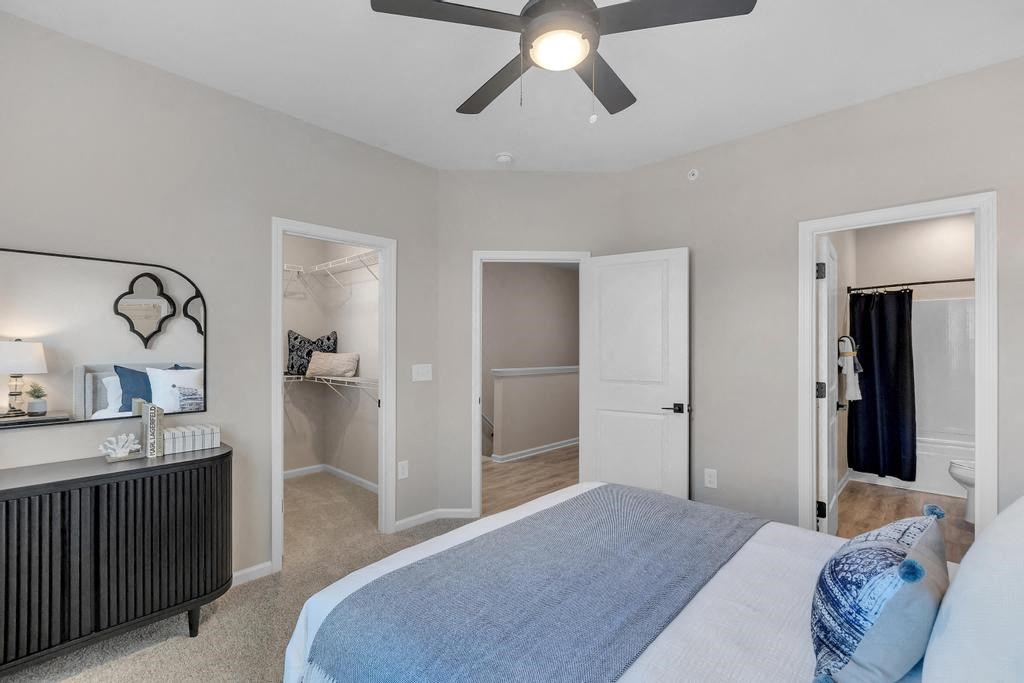 A bedroom with a bed, dresser, and mirror.
