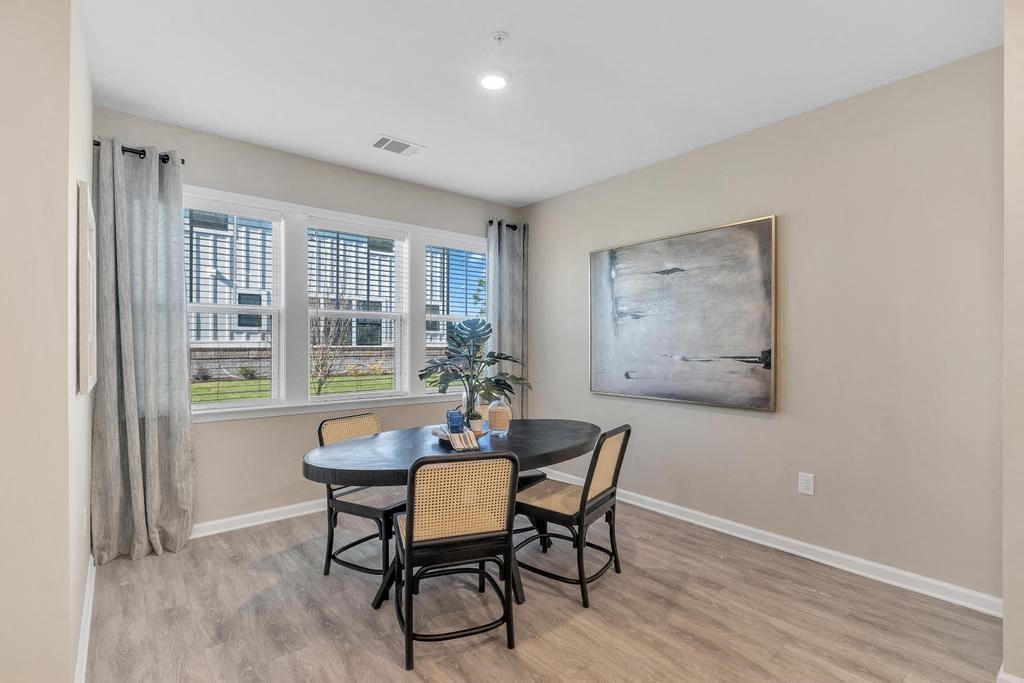 A dining room with a table and chairs.