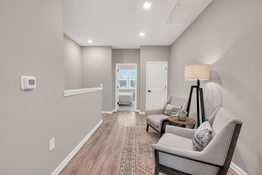 a living room with two couches and a lamp