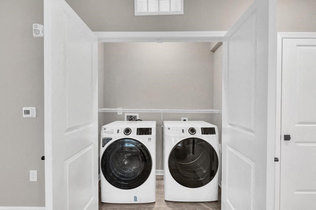 a washer and dryer in a laundry room with white doors