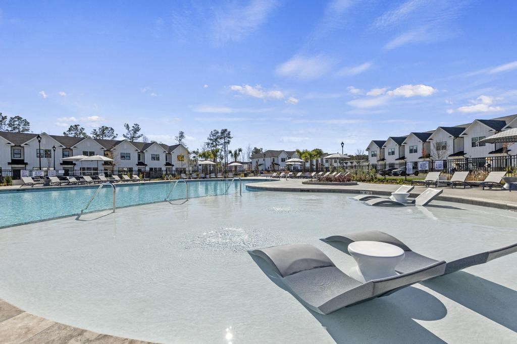 A large outdoor swimming pool with pool seating.