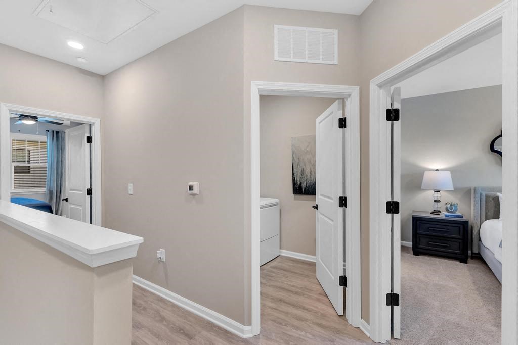 Upstairs hallway with three rooms.