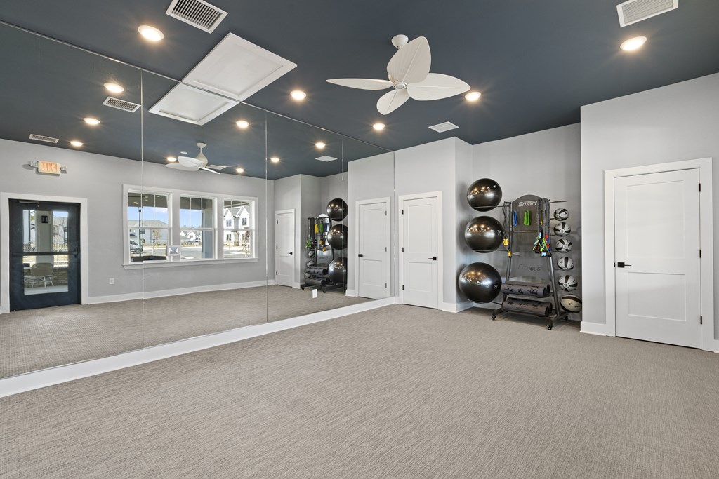 Dynamic fitness room with mirrors and exercise balls
