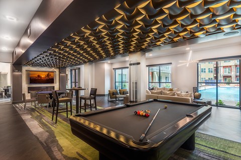a pool table in a living room with a fireplace