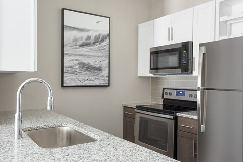 a kitchen with granite counter tops and stainless steel appliances