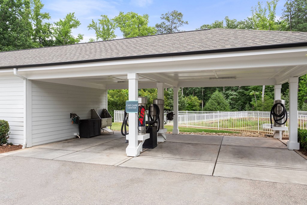 a carport with a gas pump in front of it