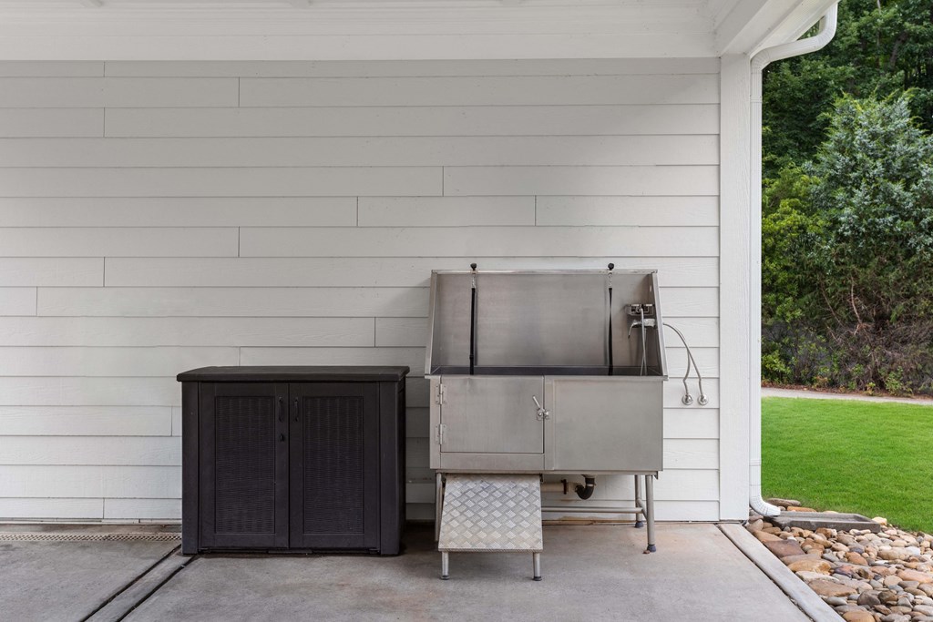 a stainless steel barbecue on the patio of a home