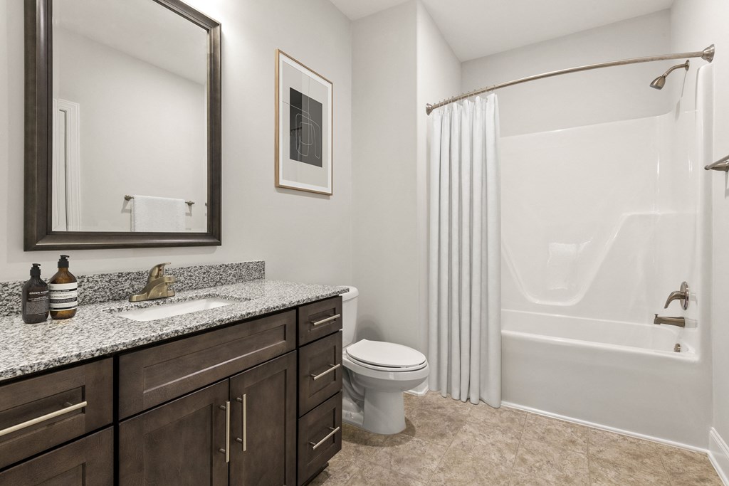 A bathroom with a toilet, sink, and bathtub.