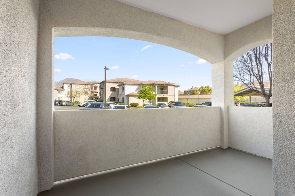a balcony with a view of a parking lot
