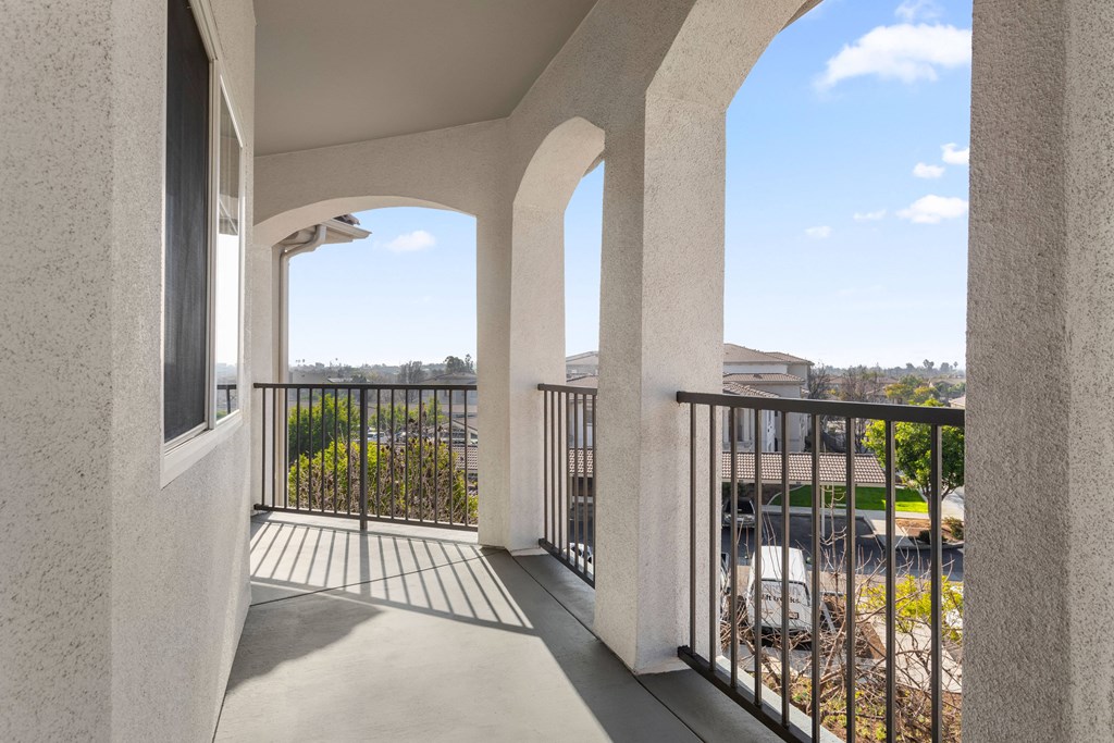 the view from the balcony of an apartment building with a balcony and a balcony railing