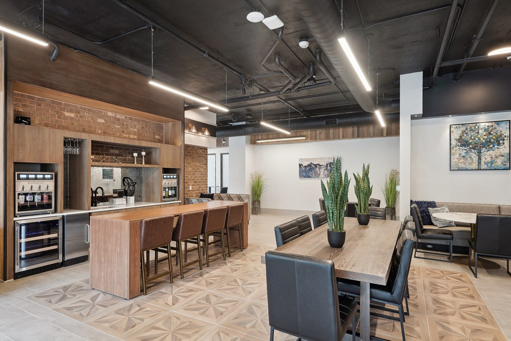 a clubhouse with a kitchen and dining area with a table and chairs