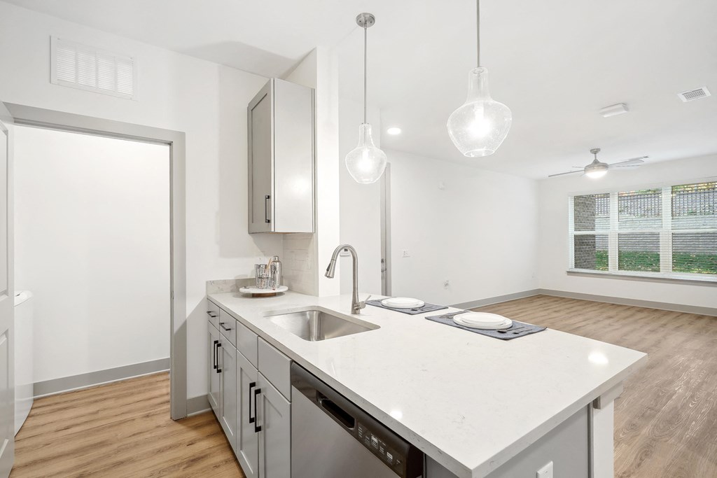 a kitchen with an island and a sink and a window