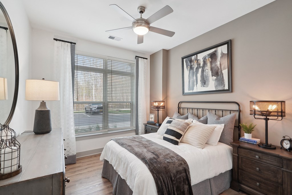 a bedroom with a bed and a ceiling fan