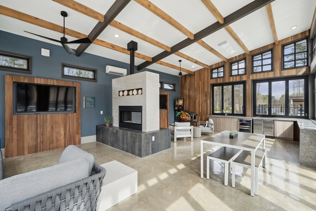 a living room with a fireplace and a table and chairs