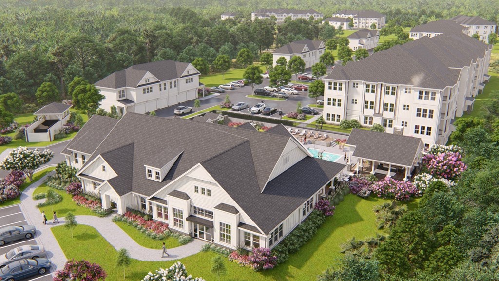 an aerial view of a large estate with houses and a parking lot