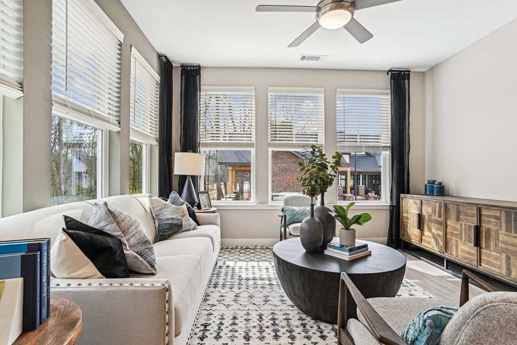 a living room with a white couch and a large window