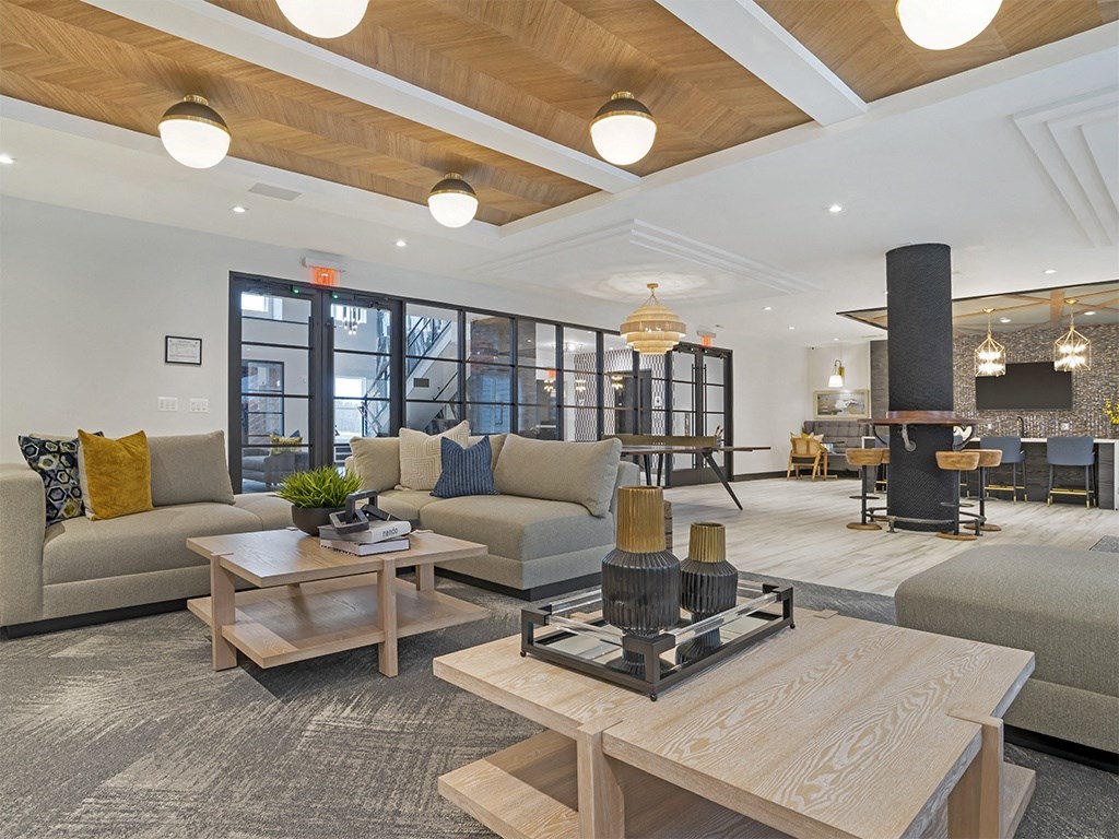 A modern living room with a wooden coffee table and a grey sofa.