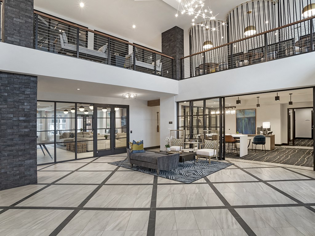 A modern living room with a large open floor plan and a balcony.