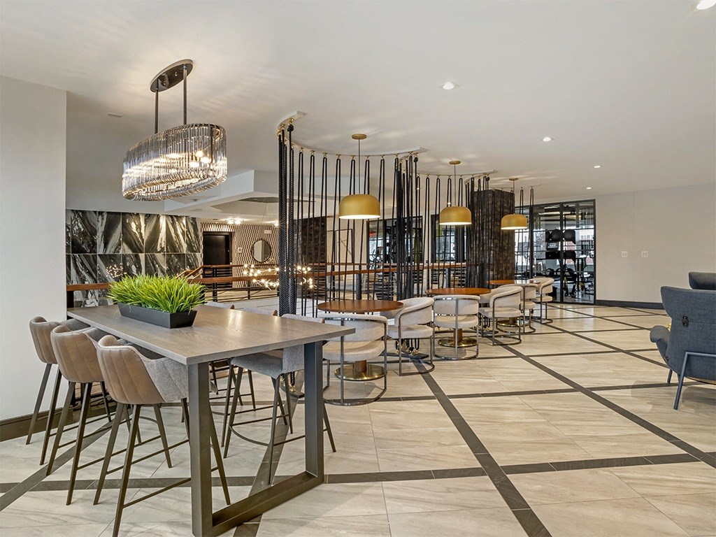 A modern dining room with a large table and chairs.