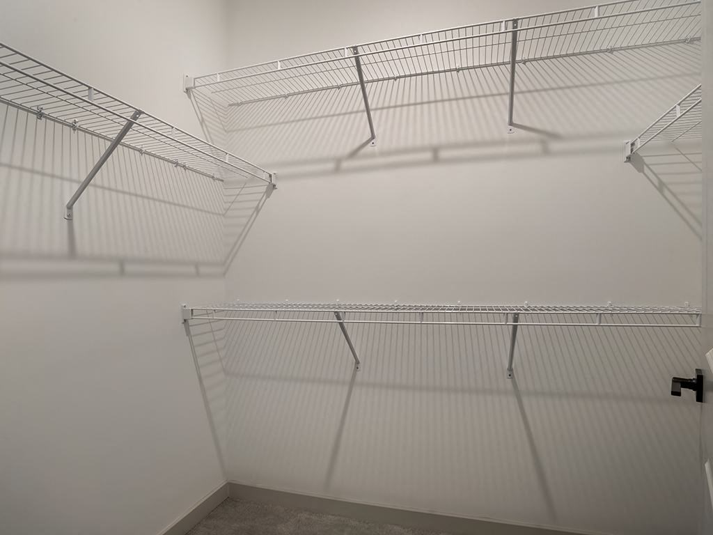 Empty wire shelving in a room.