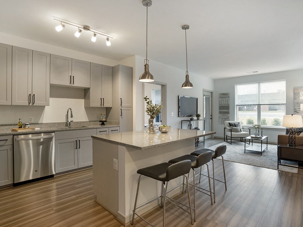 A modern kitchen with a large island and stainless steel appliances.