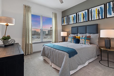 a bedroom with a bed and some pictures on the wall