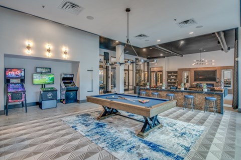 A room with a pool table and a TV.