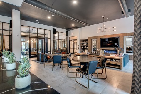 a living room with a table and chairs and a fireplace