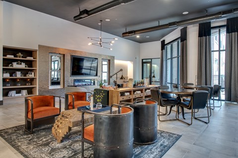 a living room with tables and chairs and a television