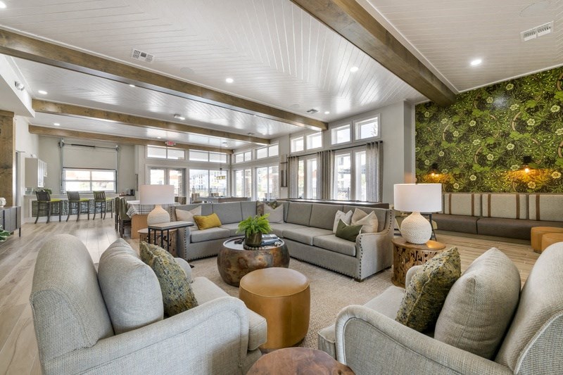 a large living room with couches and chairs