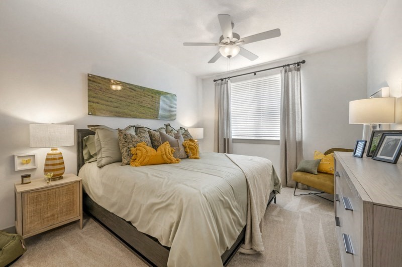 a bedroom with a large bed and a ceiling fan
