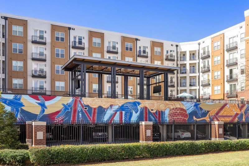 a mural on a wall in front of an apartment building