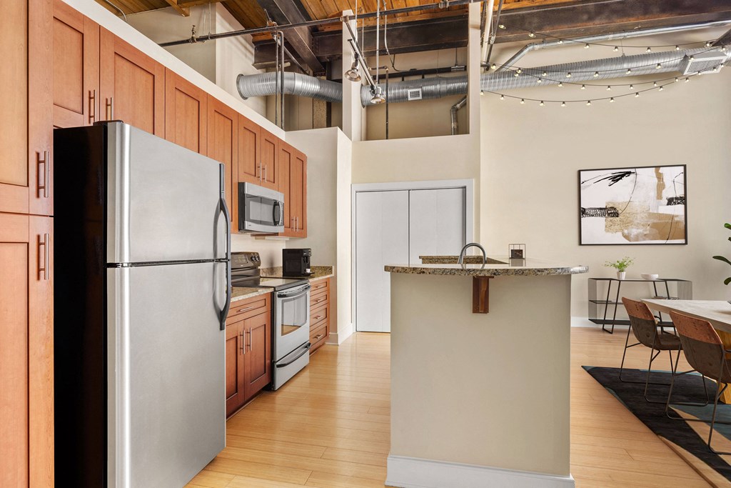 a kitchen with wood cabinets and stainless steel appliances