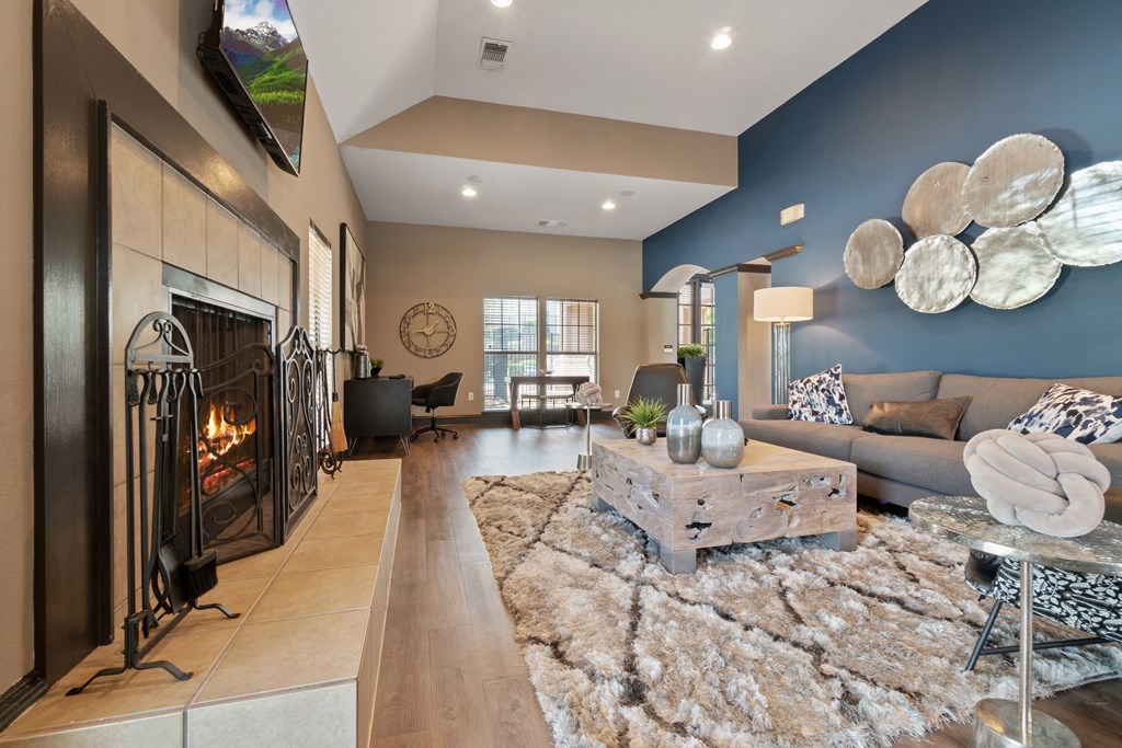 a living room with a fireplace and a blue accent wall