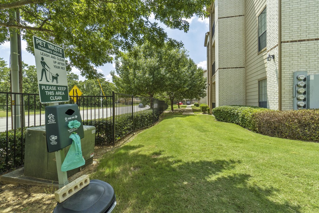 a green sidewalk in front of a building with a parking meter