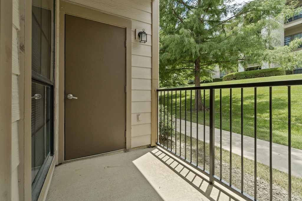 the entrance to a balcony with a door to a house