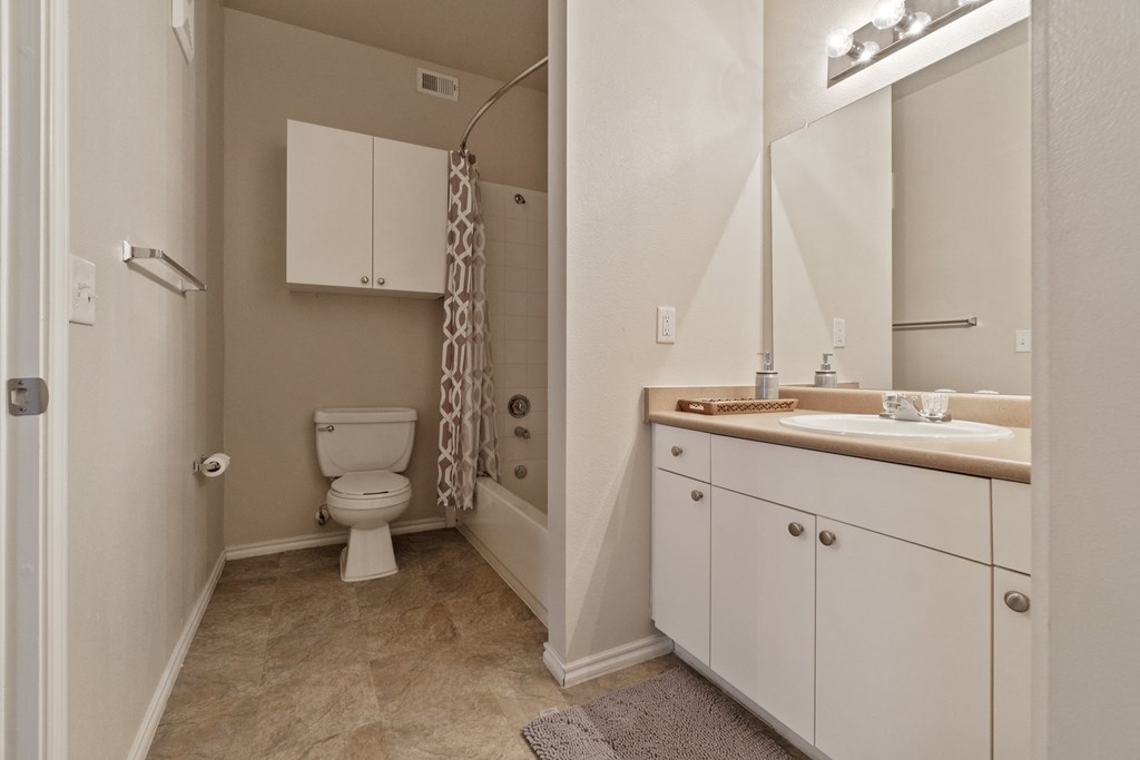a bathroom with a toilet and a sink and a shower