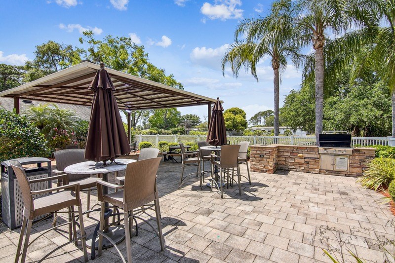A patio with a table and chairs under a canopy.