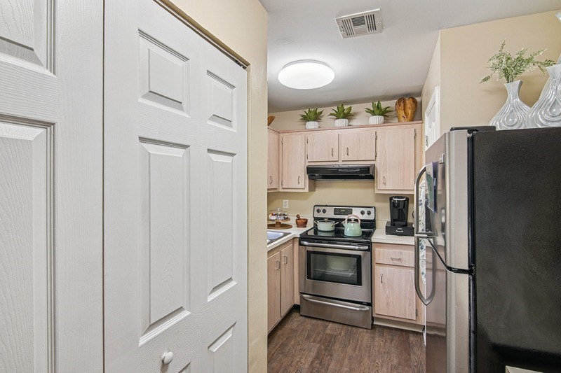 A kitchen with a white closet next to it.