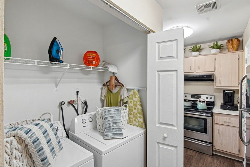 A small laundry room with a white washer and dryer.