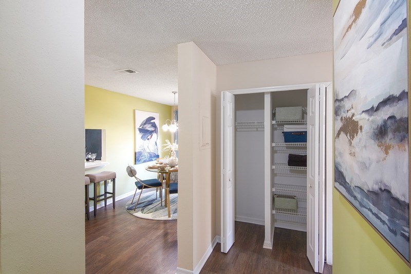 A white hallway closet with shelves inside.